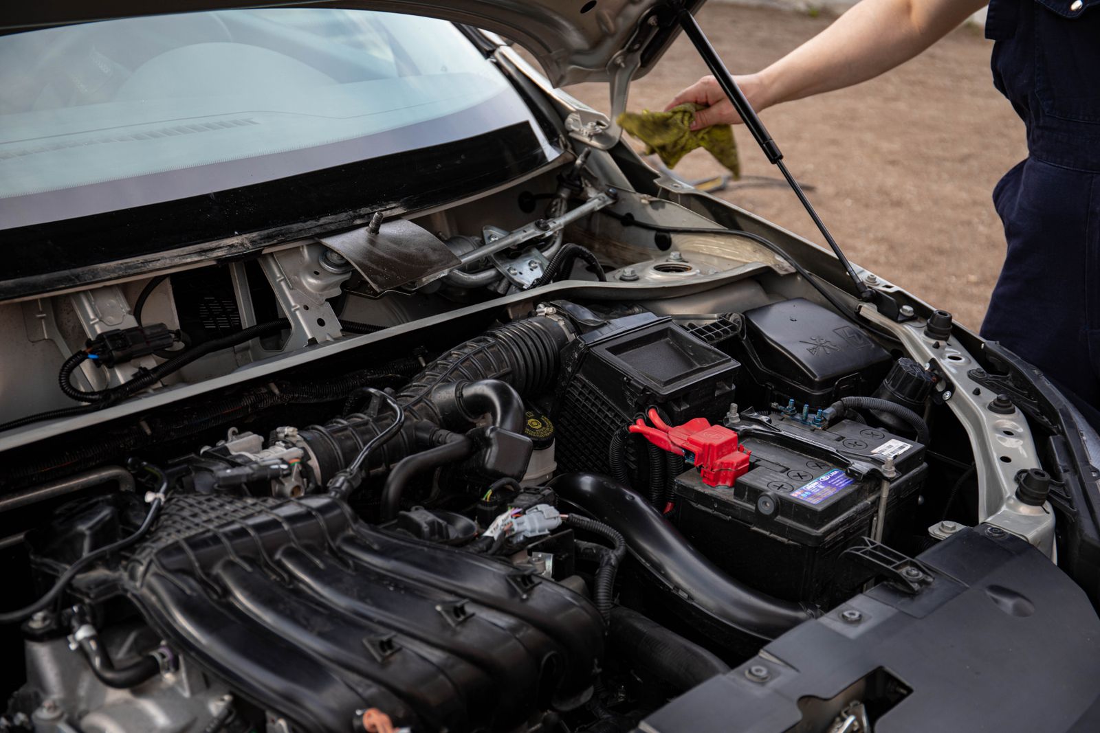 Technician checking an engine compartment