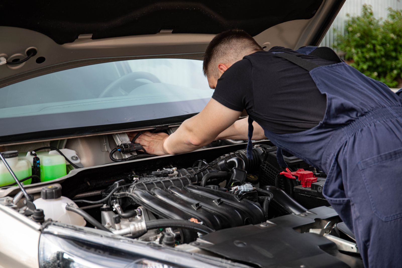 Auto technician working in an engine bay